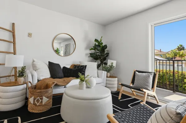 a living room with furniture a lamp and a potted plant