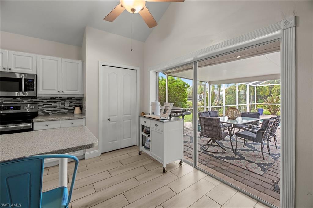21778 Brixham Run Loop Estero, FL 33928 - Photo 13 of 48 a kitchen with sink cabinets and outdoor view