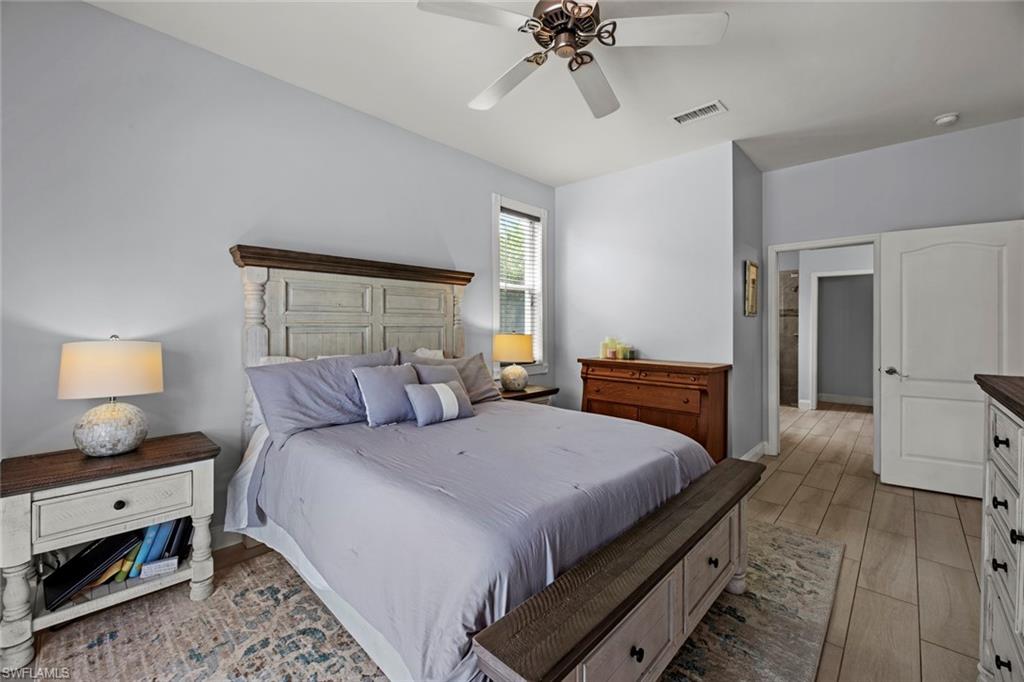 21778 Brixham Run Loop Estero, FL 33928 - Photo 16 of 48 a bedroom with a bed and wooden floor