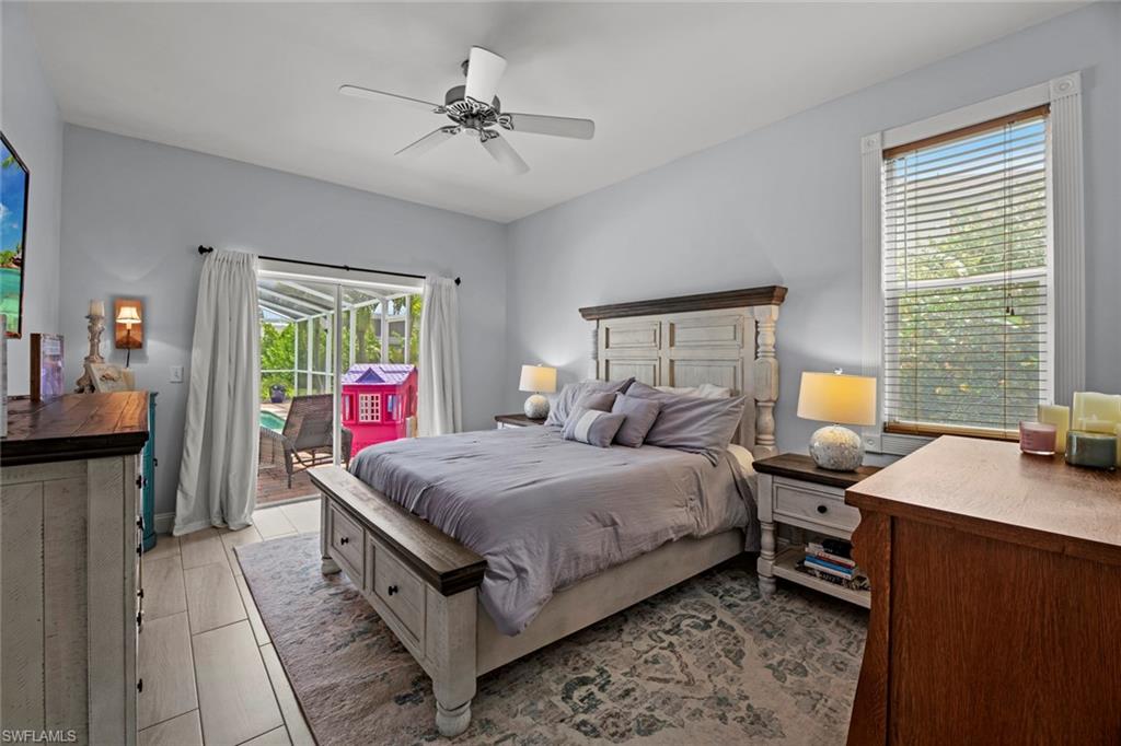 21778 Brixham Run Loop Estero, FL 33928 - Photo 17 of 48 a bedroom with a bed and a chandelier