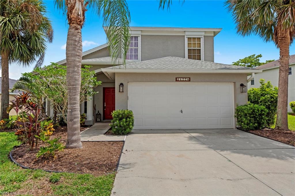 21778 Brixham Run Loop Estero, FL 33928 - Photo 2 of 48 a front view of a house with a garden