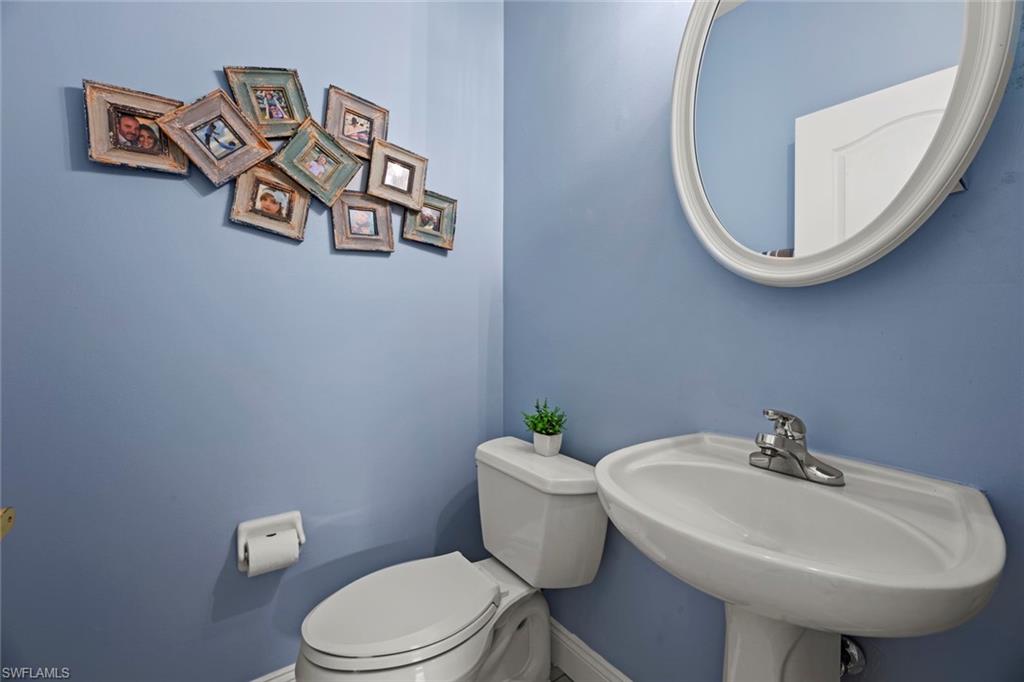 21778 Brixham Run Loop Estero, FL 33928 - Photo 24 of 48 a bathroom with a toilet a sink and mirror
