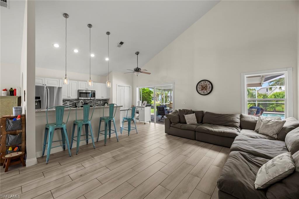 21778 Brixham Run Loop Estero, FL 33928 - Photo 3 of 48 a living room with lots of furniture and kitchen view