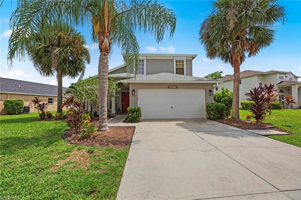 21778 Brixham Run Loop Estero, FL 33928 - Photo 35 of 48 a front view of house with small garden and palm trees