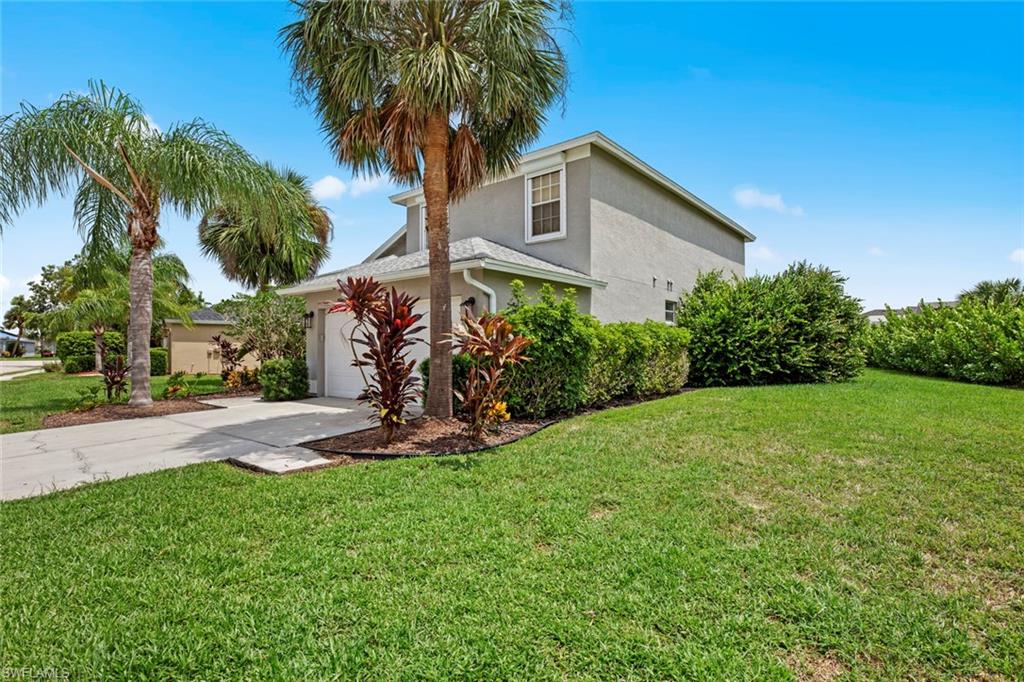 21778 Brixham Run Loop Estero, FL 33928 - Photo 37 of 48 a front view of a house with garden