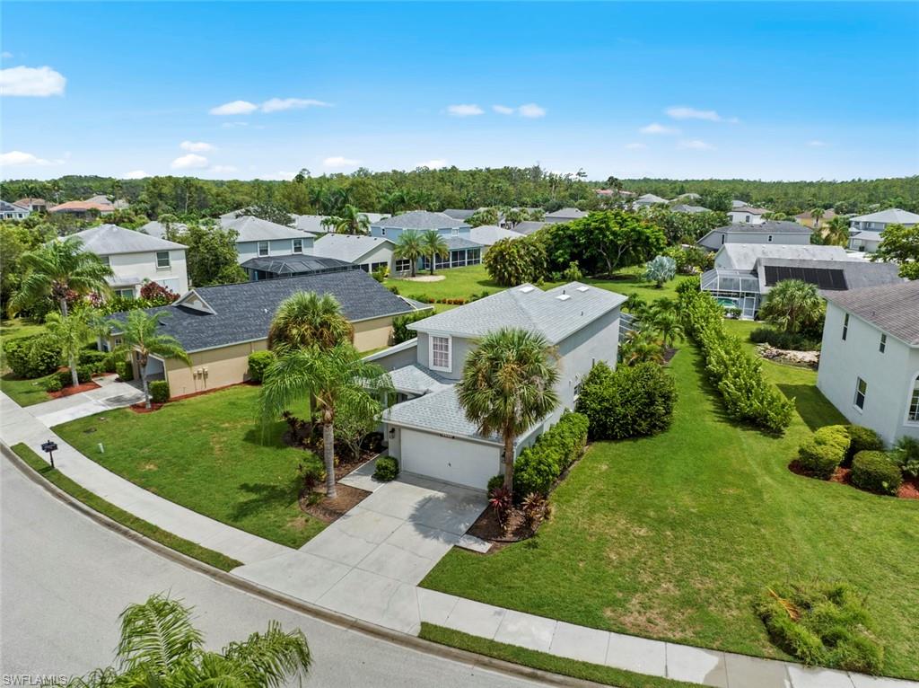 21778 Brixham Run Loop Estero, FL 33928 - Photo 38 of 48 a view of a garden with a building in the background