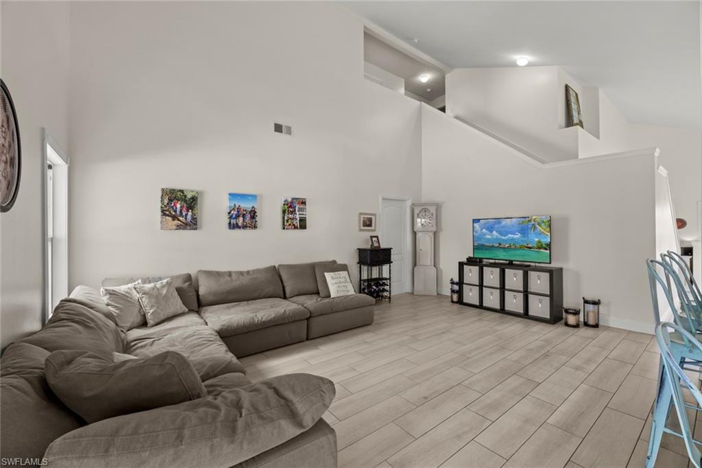 21778 Brixham Run Loop Estero, FL 33928 - Photo 4 of 48 a living room with furniture ceiling fan and a rug