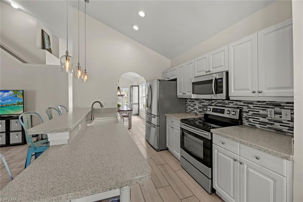 21778 Brixham Run Loop Estero, FL 33928 - Photo 6 of 48 a kitchen with a sink appliances and cabinets