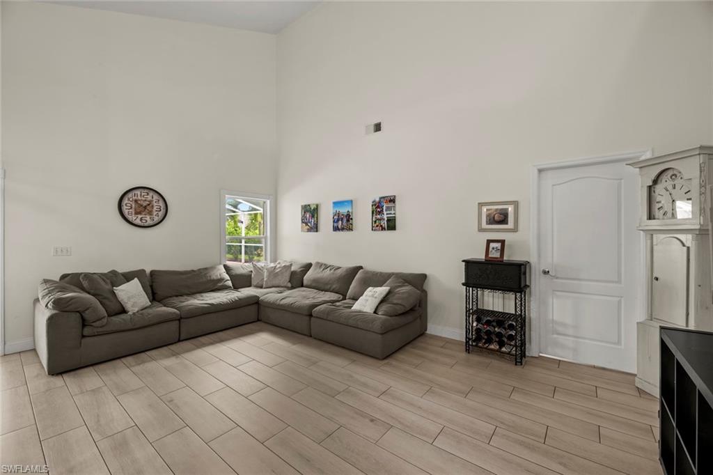 21778 Brixham Run Loop Estero, FL 33928 - Photo 10 of 48 a living room with furniture and a wooden floor