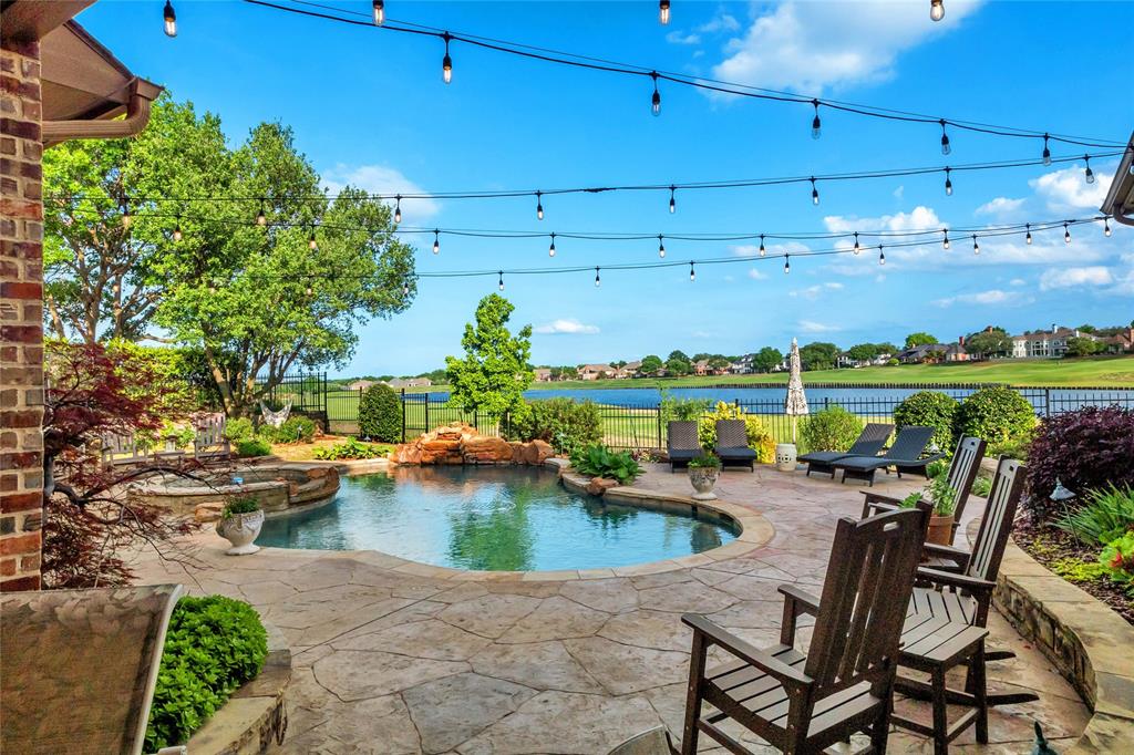 an outdoor space with patio swimming pool and plants