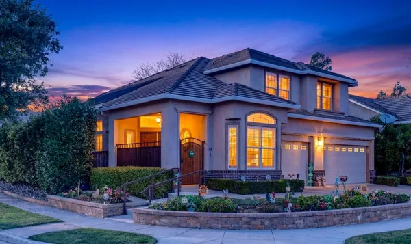a front view of a house with porch and outdoor seating