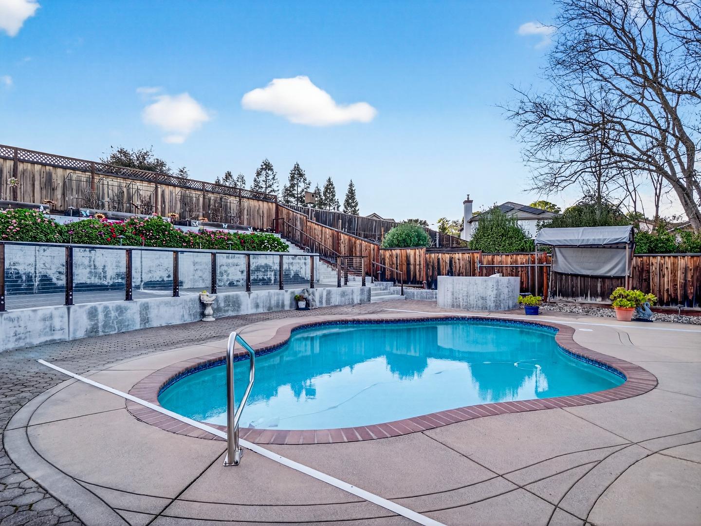 9123 Rancho Hills Drive Gilroy, CA 95020 - Photo 16 of 26 a view of a swimming pool with a lounge chairs