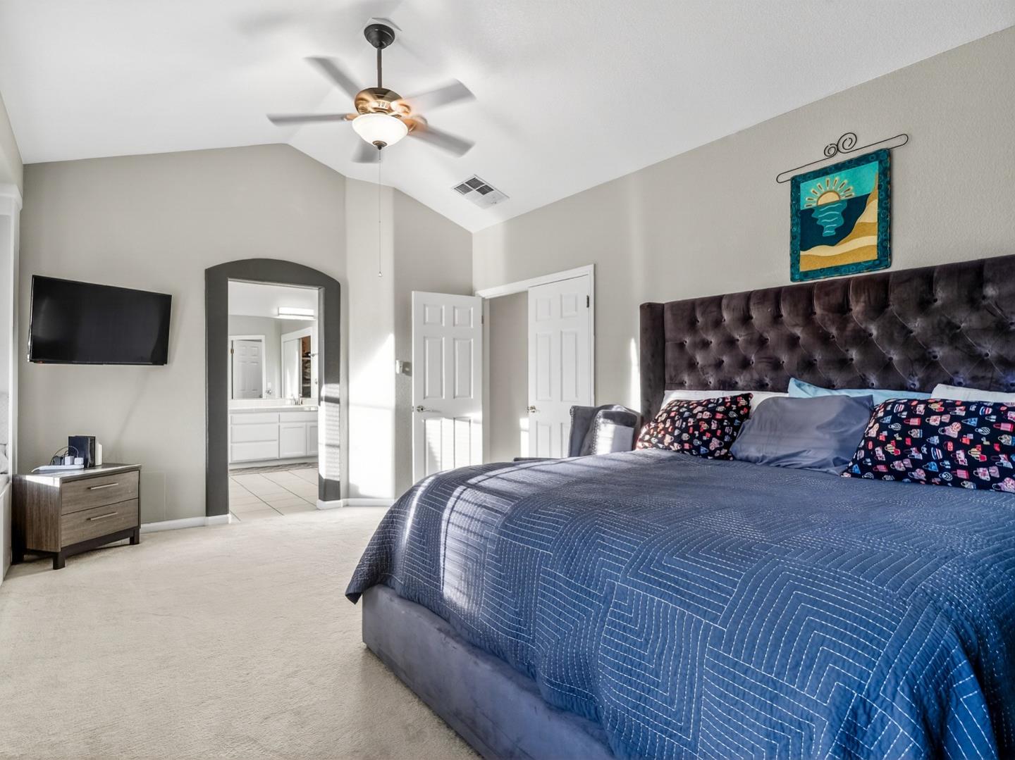 9123 Rancho Hills Drive Gilroy, CA 95020 - Photo 8 of 26 a bedroom with bed and a chandelier