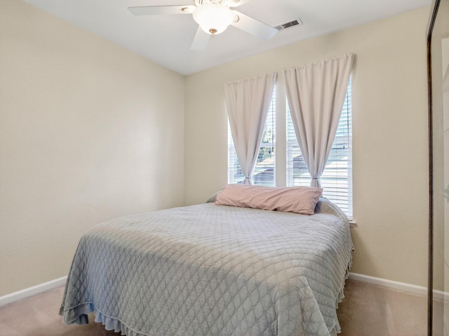 9123 Rancho Hills Drive Gilroy, CA 95020 - Photo 9 of 26 a bedroom with a bed and a large window