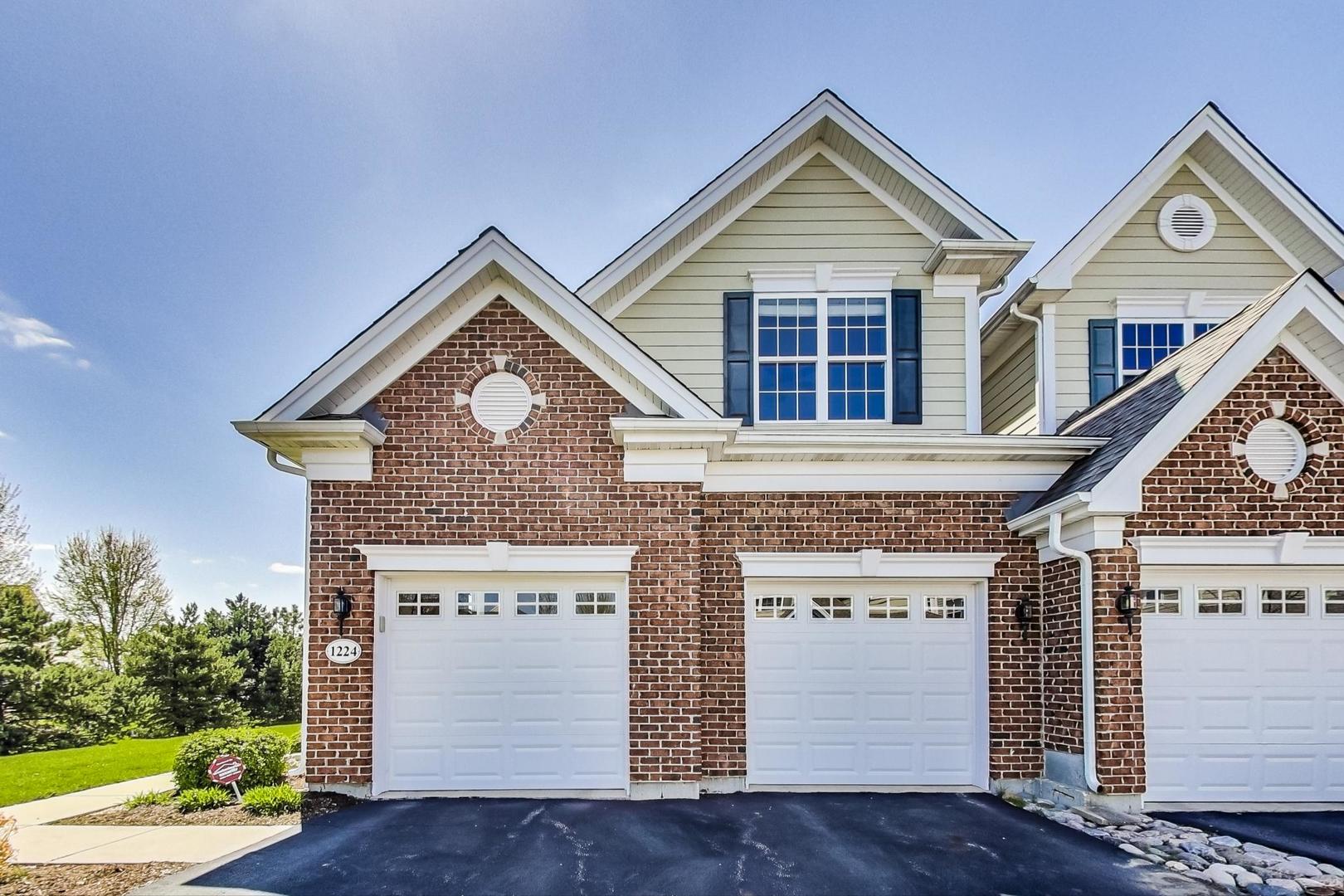 1224 Falcon Ridge Drive Elgin, IL 60124 - Photo 1 of 27 a front view of a house with a yard