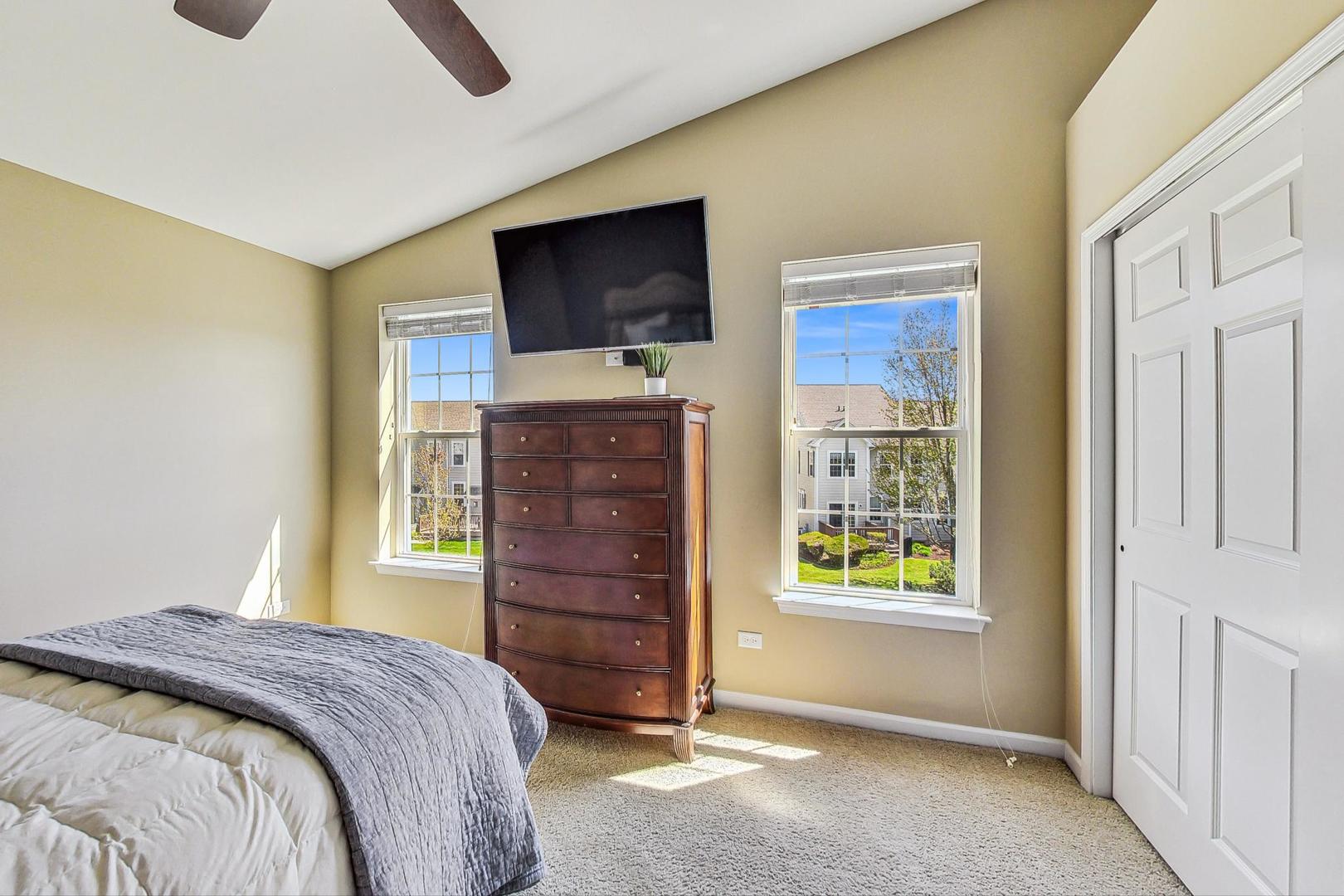 1224 Falcon Ridge Drive Elgin, IL 60124 - Photo 16 of 27 a bedroom with a bed and a flat screen tv