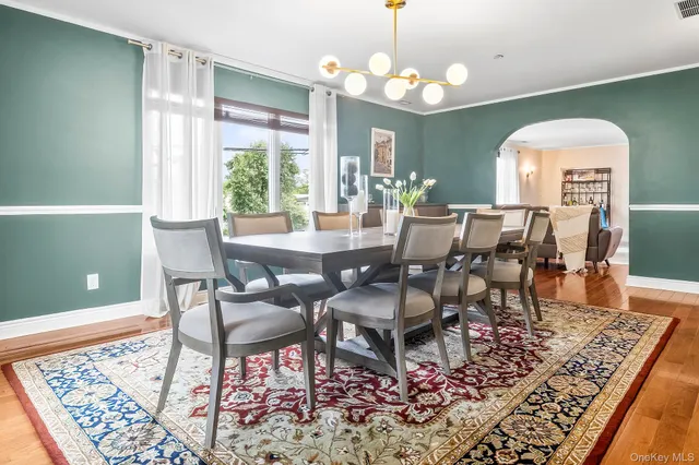 a living room with furniture wooden floor and a large window