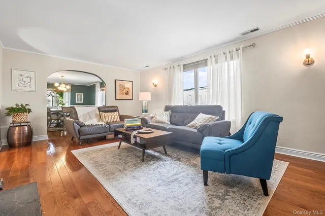 a living room with furniture a fireplace and next to a window