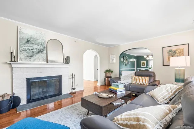a living room with furniture a lamp and a window