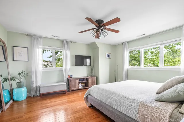 a bedroom with a bed and a mirror