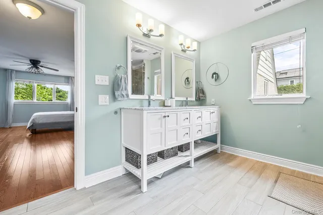 a white bath tub sitting next to a bathroom sink