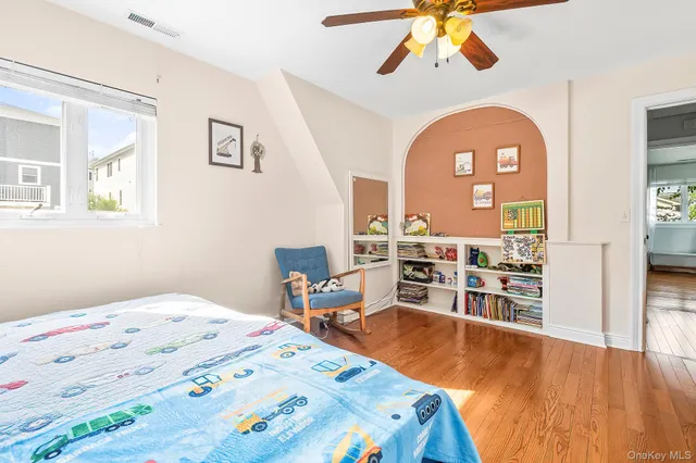 a bed sitting in a bedroom next to a window