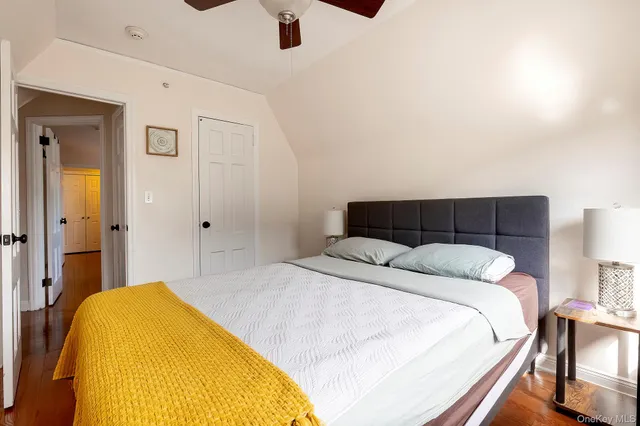 a bathroom with a toilet sink vanity granite and shower