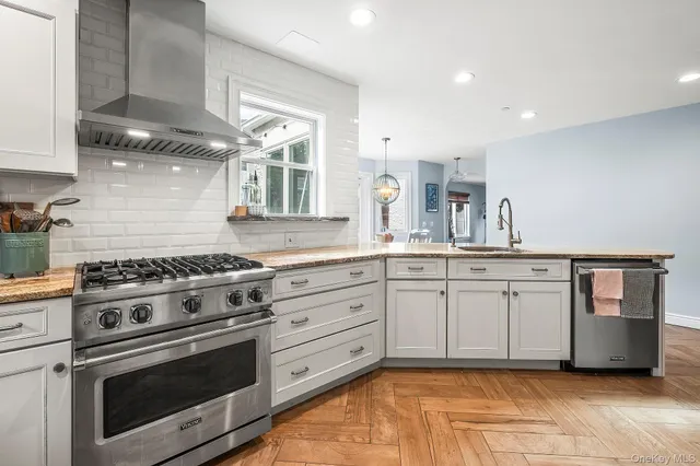 a kitchen with granite countertop cabinets stainless steel appliances and a counter space