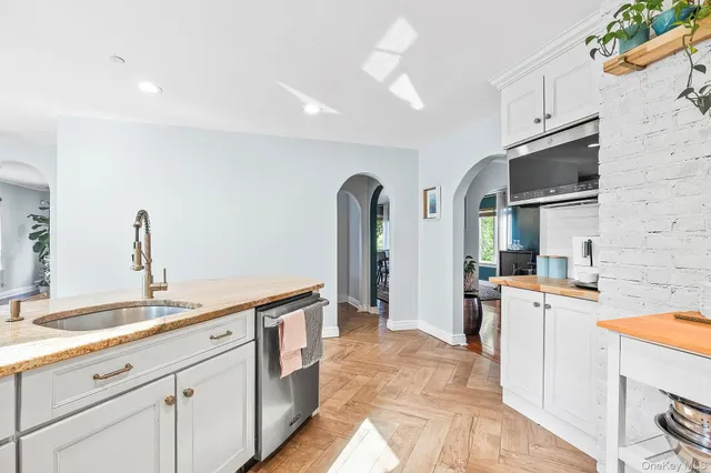 a dining room with furniture a chandelier and wooden floor
