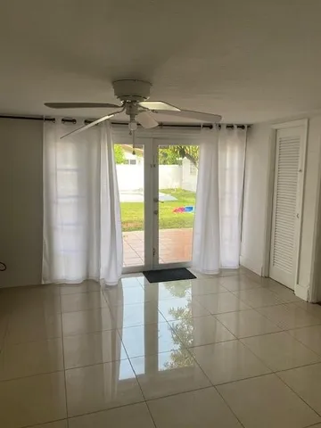 a view of an empty room with a fireplace and a window