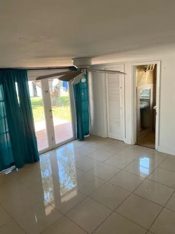 an empty room with windows and closet