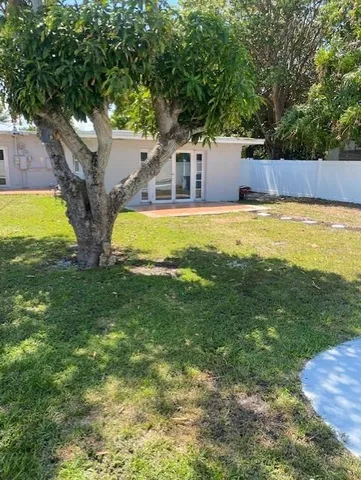 a view of a house with pool and a yard