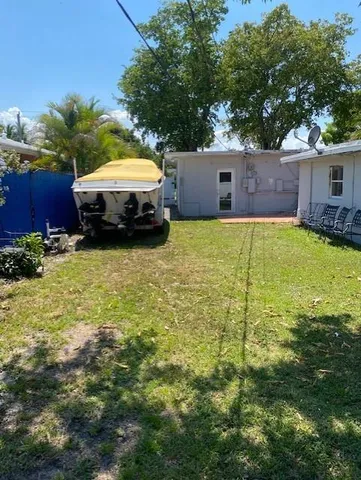 a swimming pool with outdoor seating and yard