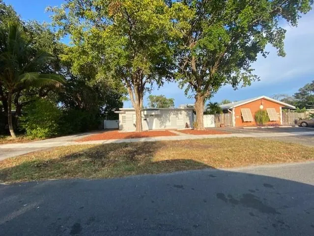 a view of a house with a yard and garage