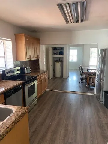 a view of a dining room with furniture and wooden floor