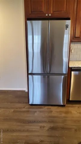 a view of a refrigerator in wooden floor