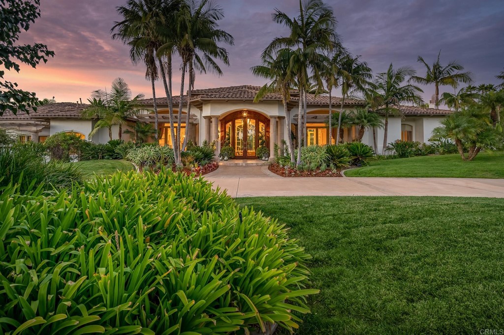6424 La Valle Plateada Rancho Santa Fe, CA 92067 - Photo 2 of 21 a front view of a house with yard and green space