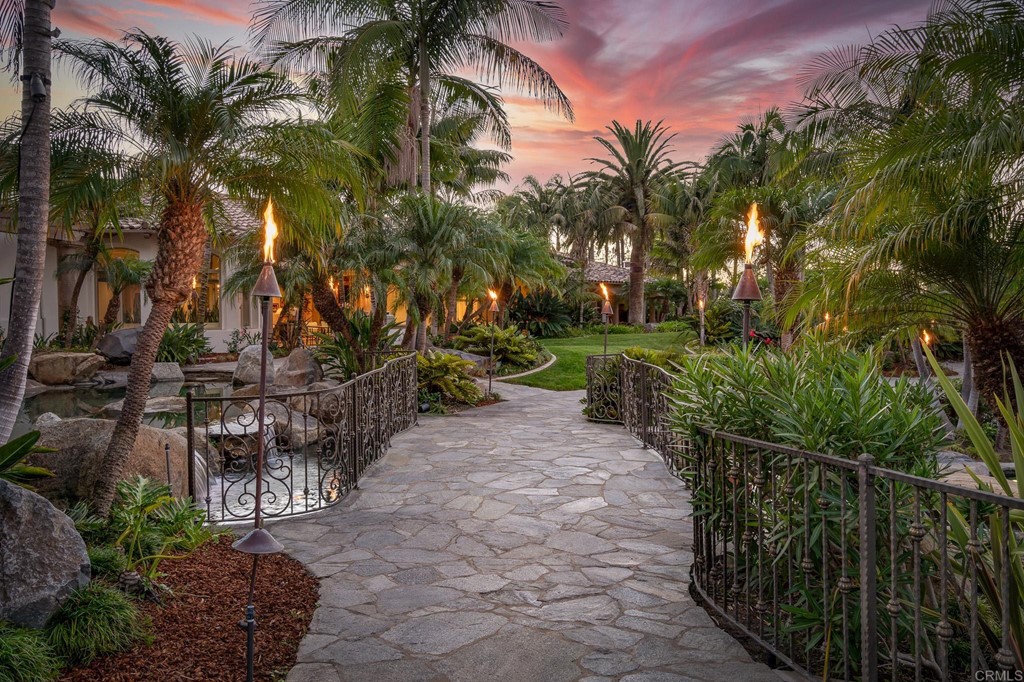 6424 La Valle Plateada Rancho Santa Fe, CA 92067 - Photo 17 of 21 a view of a backyard with potted plants and large trees