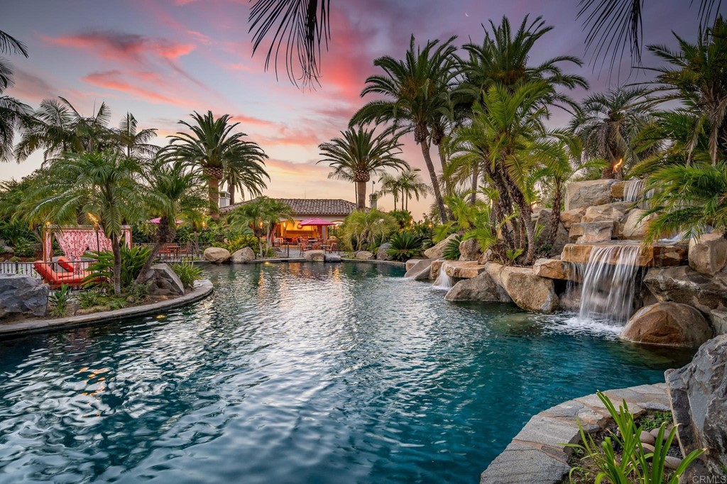 6424 La Valle Plateada Rancho Santa Fe, CA 92067 - Photo 18 of 21 a view of swimming pool with lawn chairs with plants and palm trees