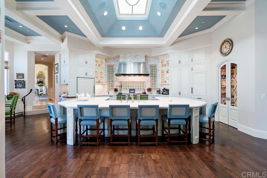 6424 La Valle Plateada Rancho Santa Fe, CA 92067 - Photo 5 of 21 a dining room with stainless steel appliances wooden floors a table and chairs