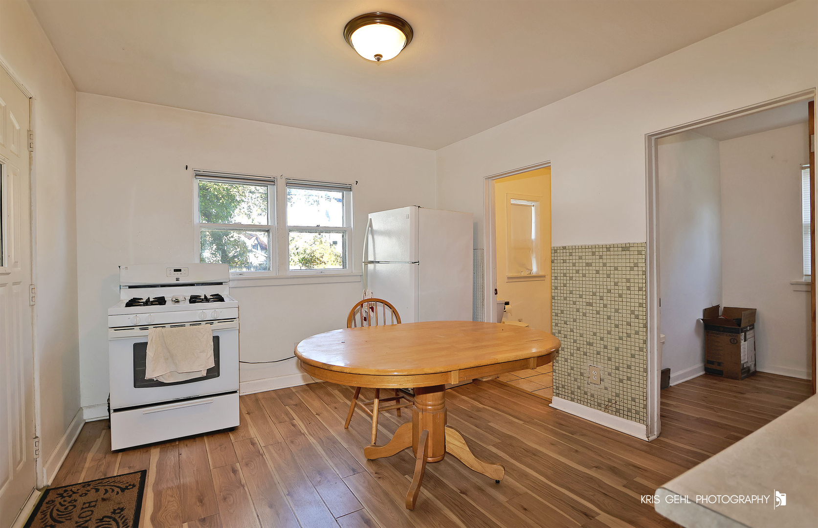 428 North Poplar Street Waukegan, IL 60085 - Photo 7 of 22 a kitchen with a table chairs and a refrigerator
