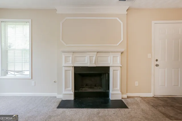 a living room with a fireplace and a window