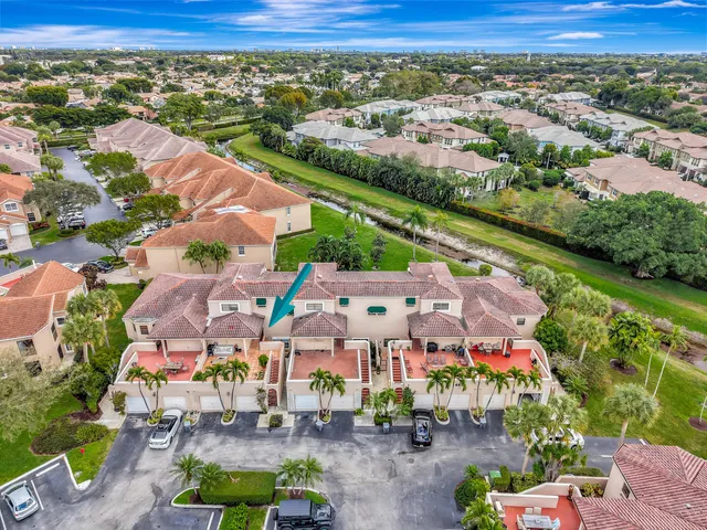 an aerial view of residential houses with outdoor space and street view
