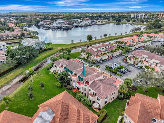 an aerial view of lake and residential houses with outdoor space