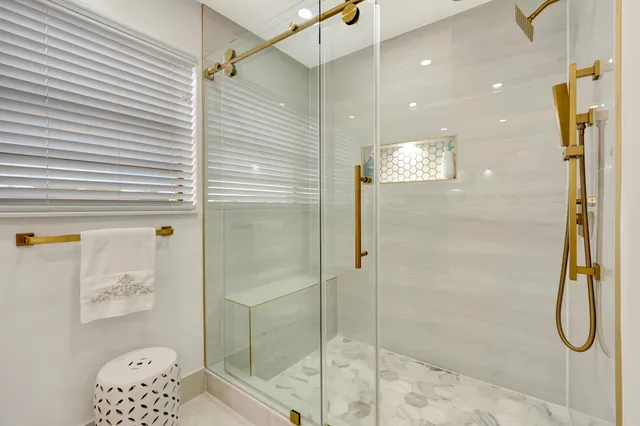 a kitchen with stainless steel appliances granite countertop a stove a sink and white cabinets