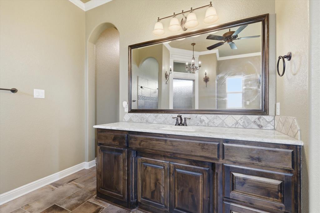 160 Vista Ridge North Decatur, TX 76234 - Photo 24 of 40 a bathroom with a granite countertop sink and a mirror