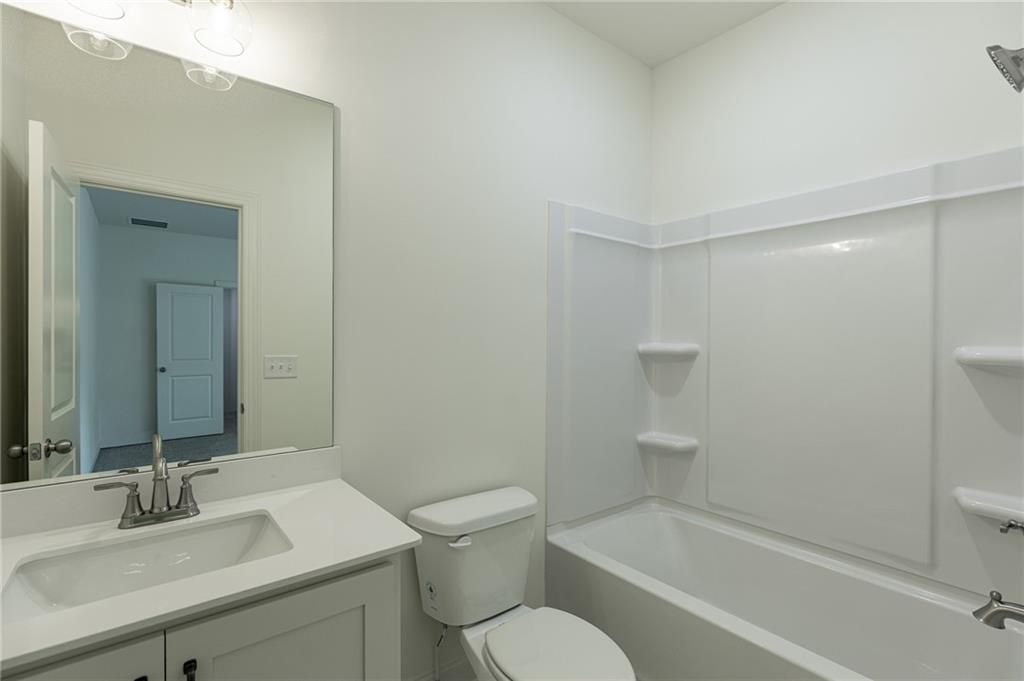 1210 Austin Road Winder, GA 30680 - Photo 44 of 56 a bathroom with a sink a toilet and shower
