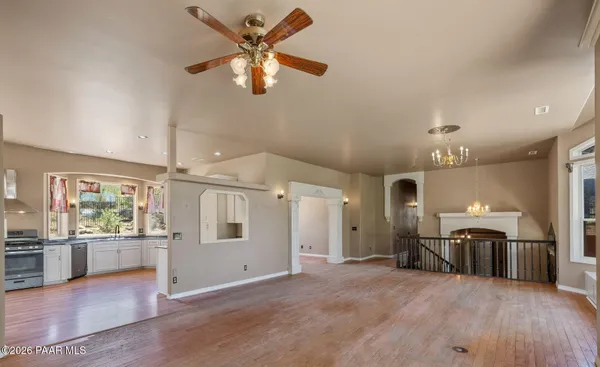 an empty room with closet and a ceiling fan