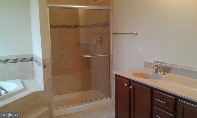 4 Elmer Derr Road Frederick, MD 21703 - Photo 14 of 26 a bathroom with a granite countertop sink mirror and shower