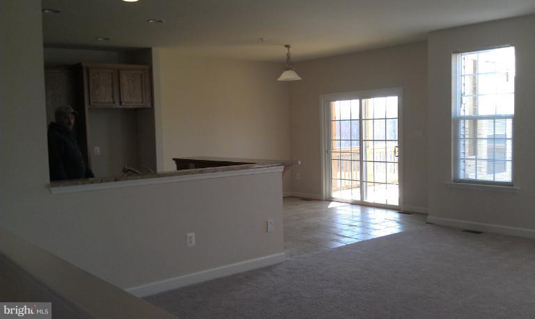 4 Elmer Derr Road Frederick, MD 21703 - Photo 8 of 26 an empty room with wooden floor and windows